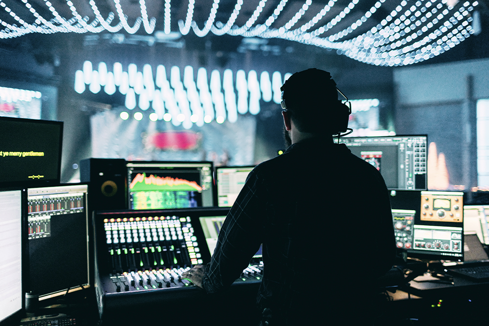 An AV equipment technician managing the lights and audio for an event