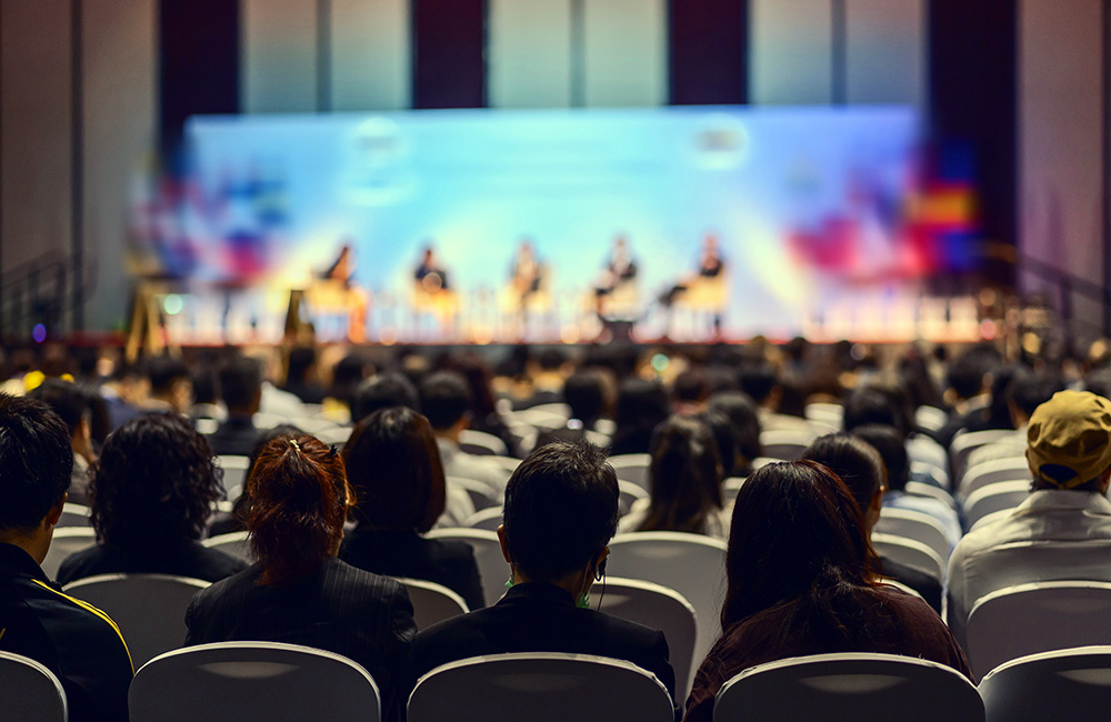 people in audience of an in-person event production